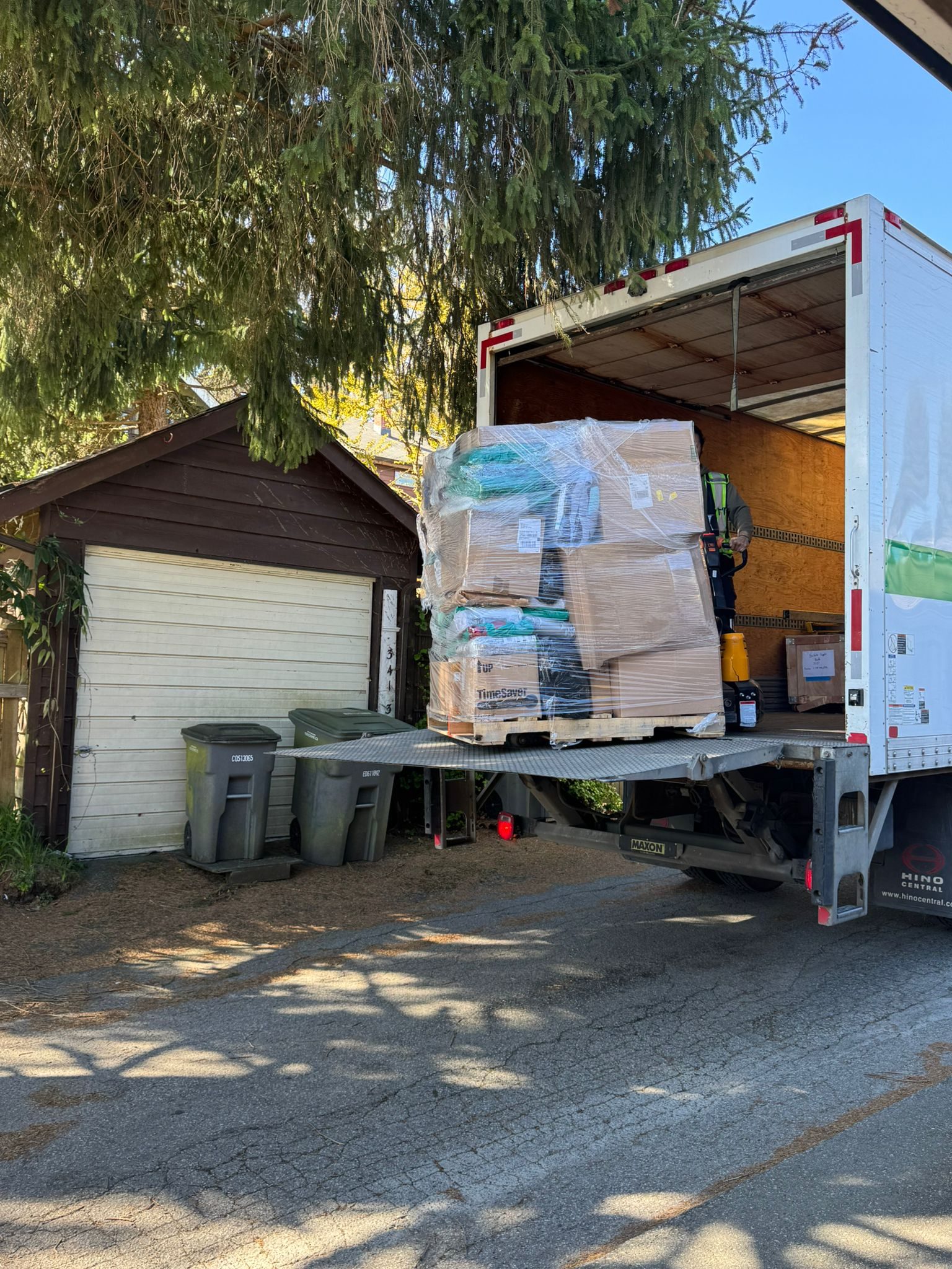 April 2026 Delivery - Delivery truck with wrapped pallet on lift gate