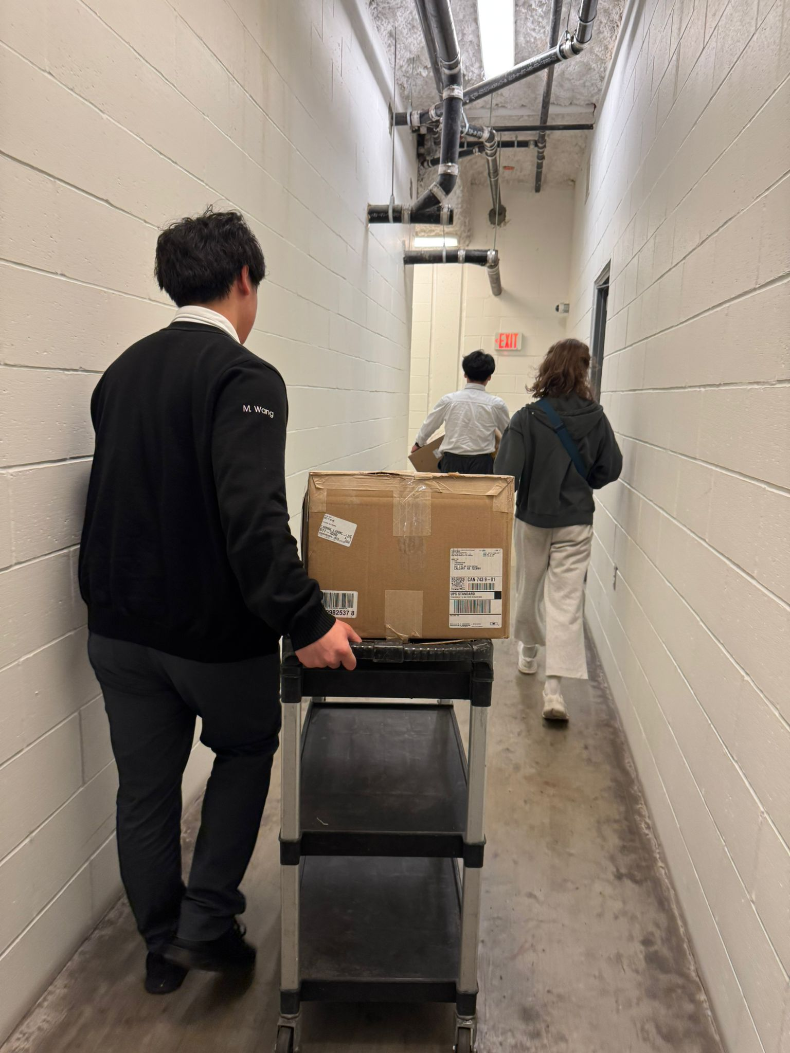 Post-Easter 2026 - Volunteers walking through BCIHS building corridor with cart