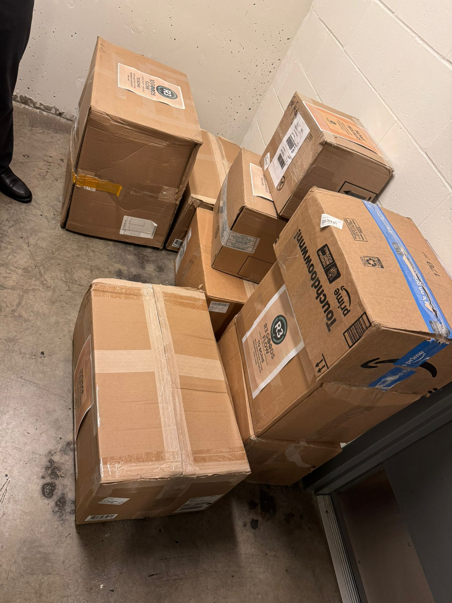 Post-Easter 2026 - Donation boxes with R3 GOODS FLOW labels stacked at BCIHS