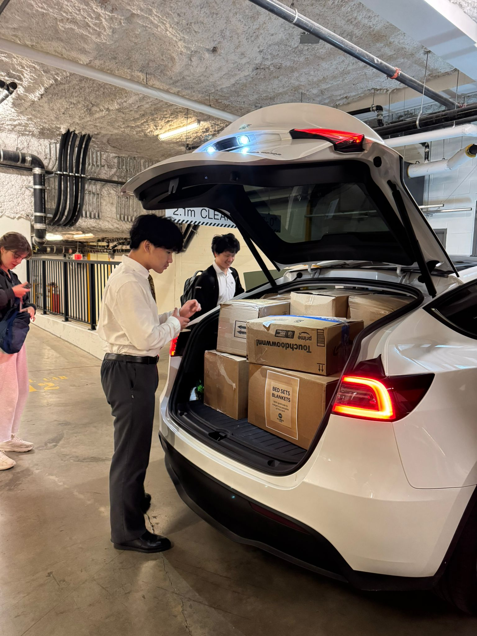 Post-Easter 2026 - Volunteer team coordinating at car with donation boxes
