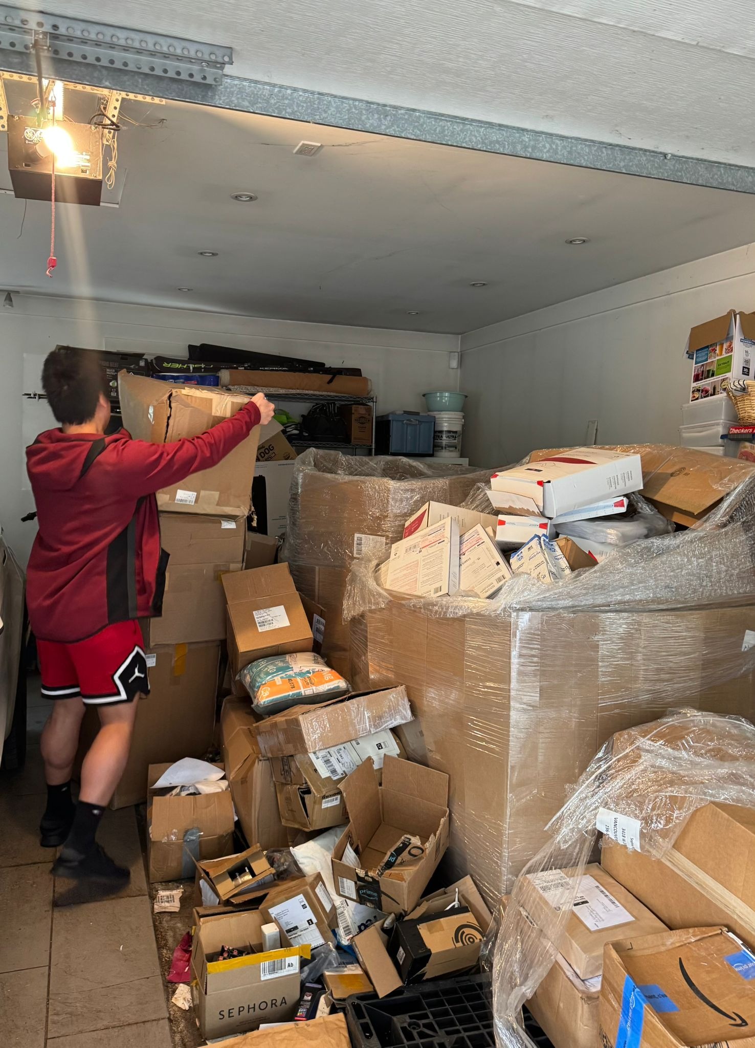 Heading into 2026 Batch - R3 team organizing boxes stacked high in garage