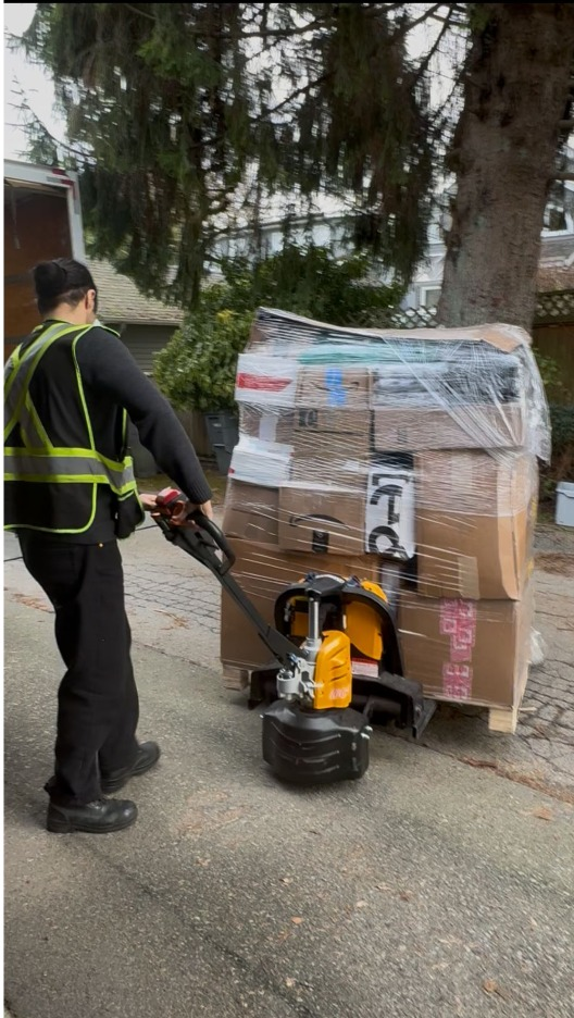 Heading into 2026 Batch - Delivery worker from behind pulling pallet with jack