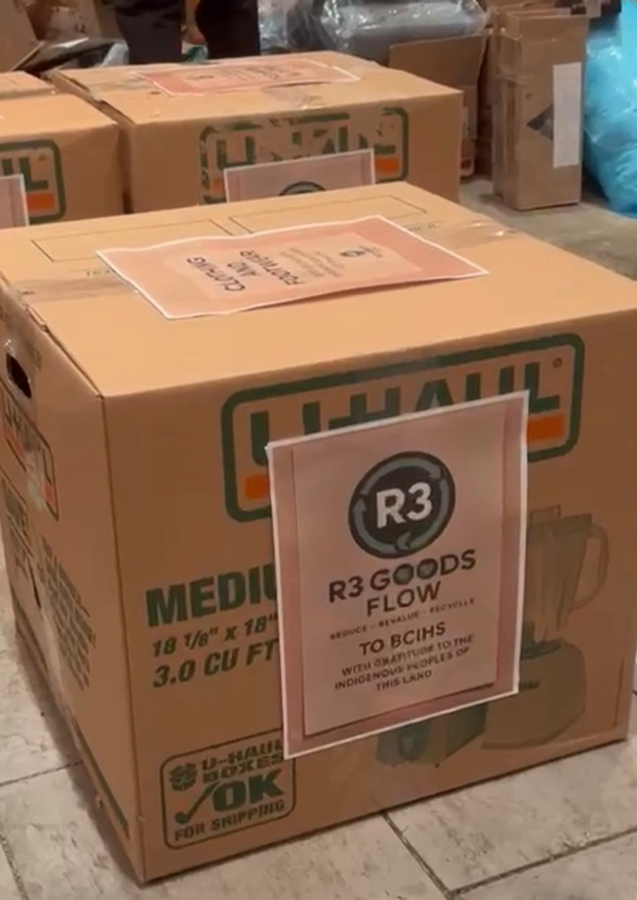 Thanksgiving Donation - Close-up of donation box with R3 Goods Flow and gratitude message to Indigenous peoples