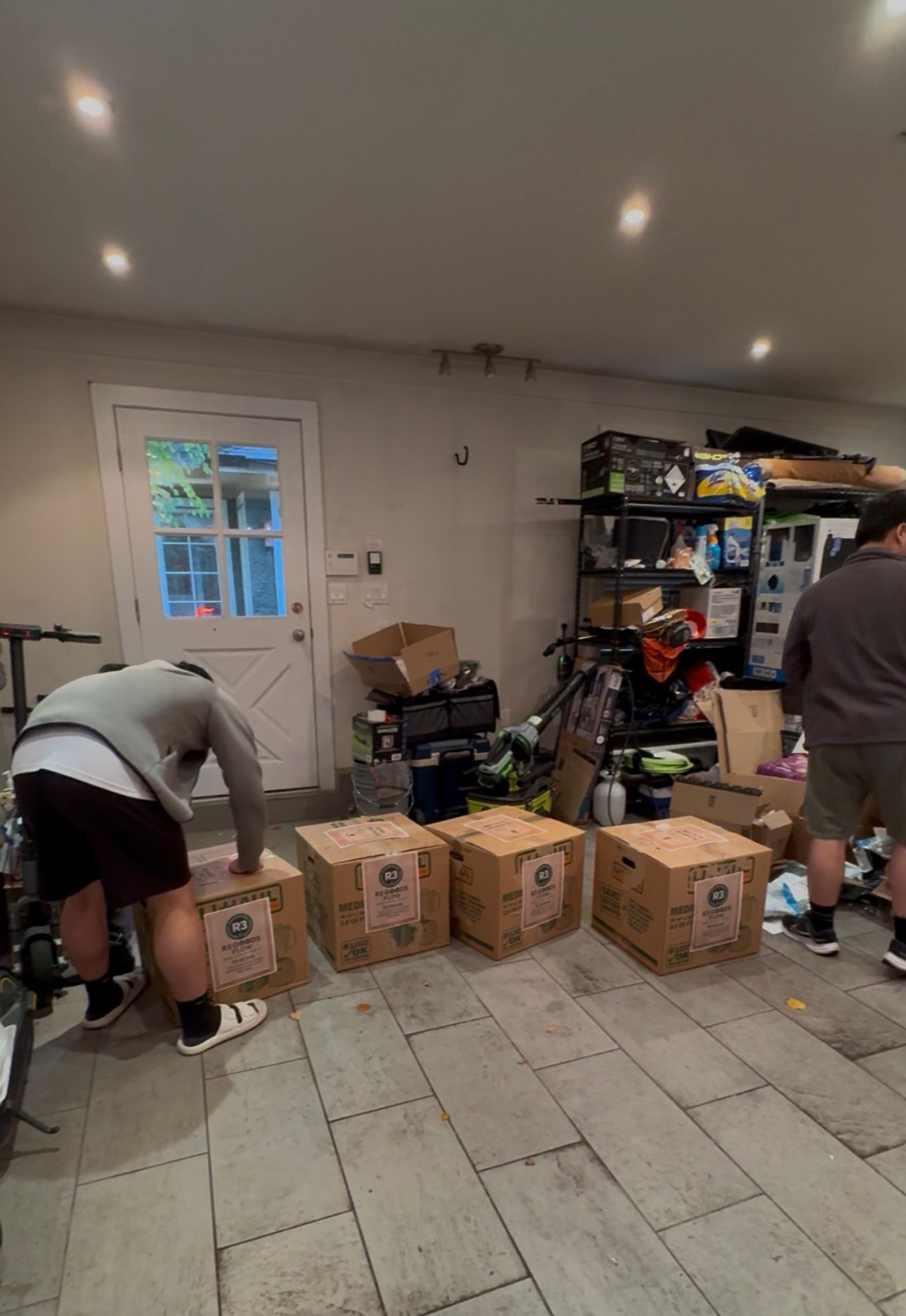 Thanksgiving Donation - Multiple R3 Goods Flow boxes organized in garage